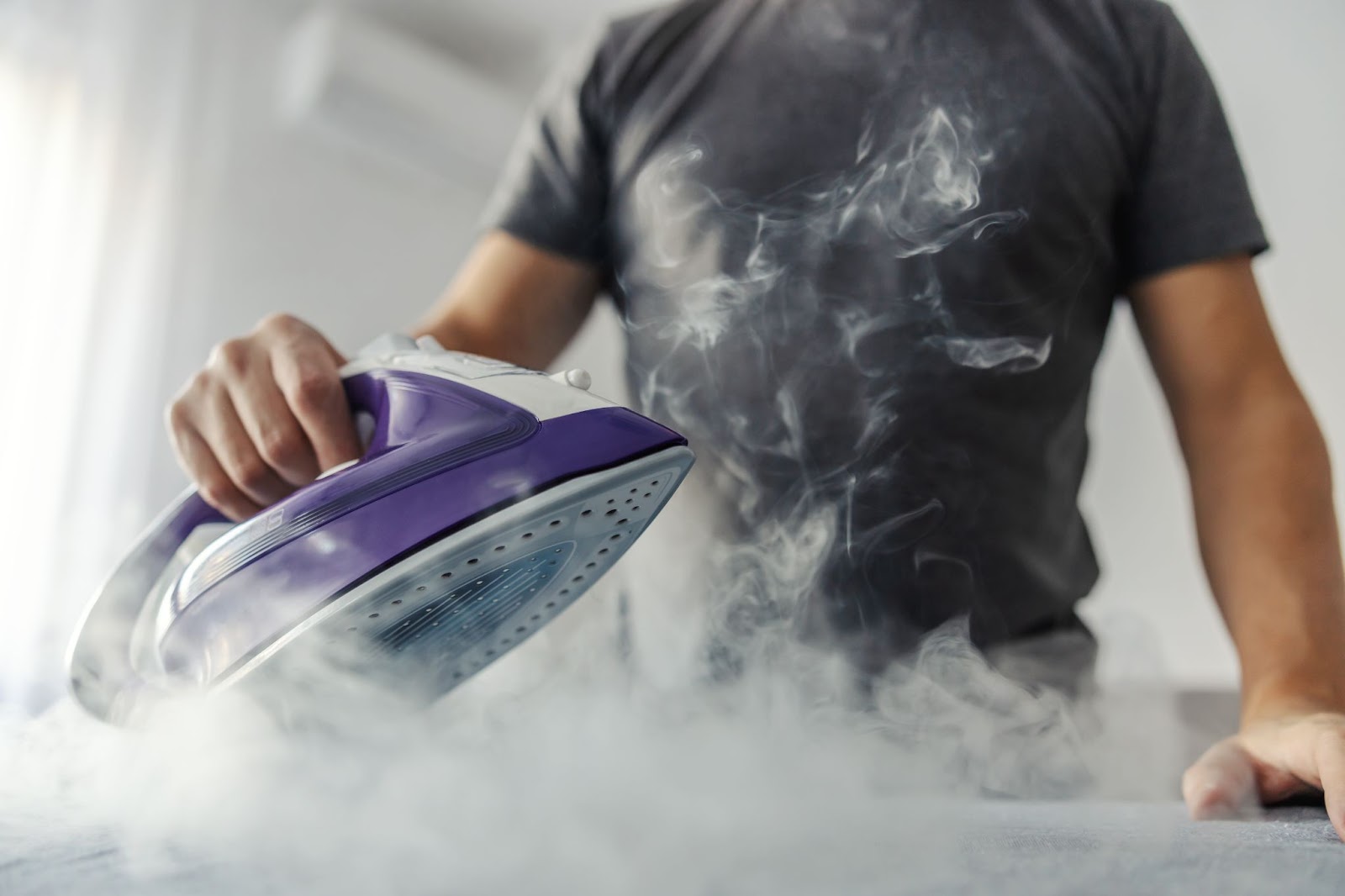 Man using a steam iron