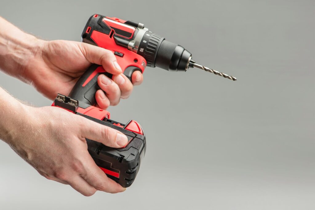 photo of a hand removing a drill battery