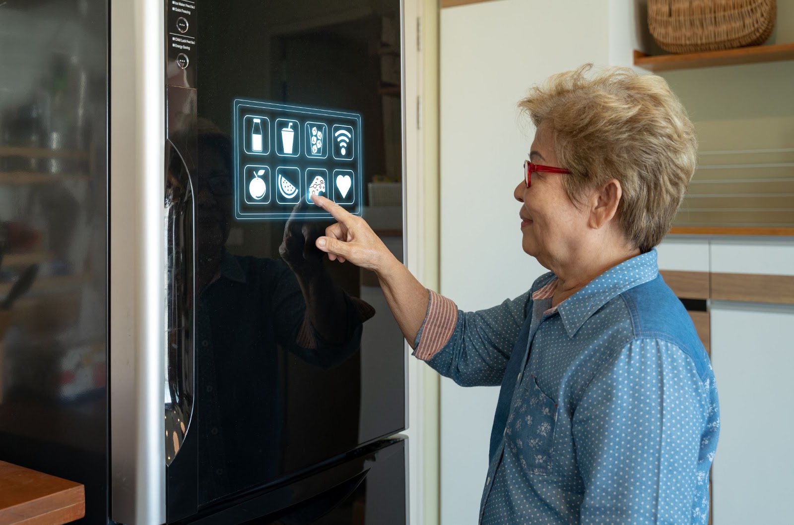 Woman tapping app icons on the touch display of a smart refrigerator door